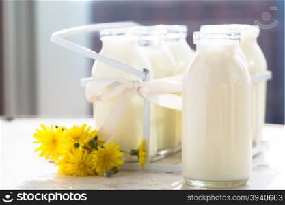 Bottles of fresh milk on a kitchen table