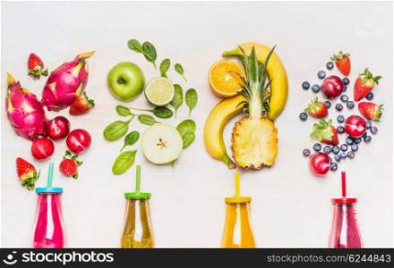 Bottles of Fruits smoothies with various ingredients on white wooden background, top view. Superfoods and healthy lifestyle or detox diet food concept.
