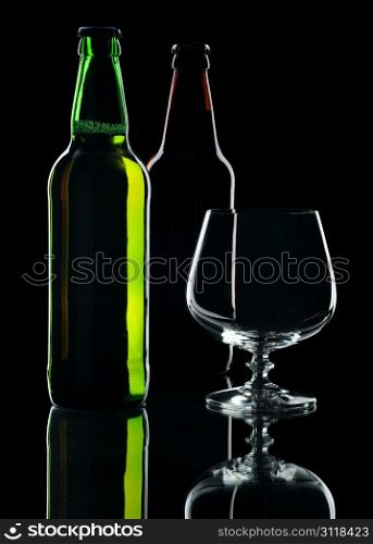 Bottles of lager beer from green and brown glass, isolated on a black background.