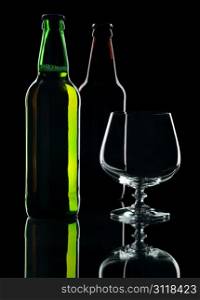 Bottles of lager beer from green and brown glass, isolated on a black background.