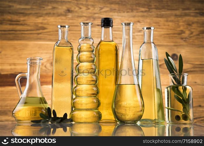 Bottles of olive oil, olive branch and Cooking oils