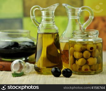 bottles of olive oil with black and green olives