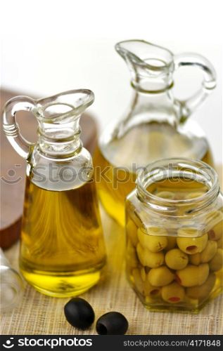 bottles of olive oil with black and green olives