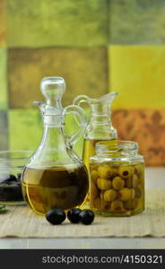 bottles of olive oil with olives