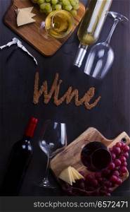 Bottles of red and white wine with wine glasses and grape on table with wine letters. Glass of red wine