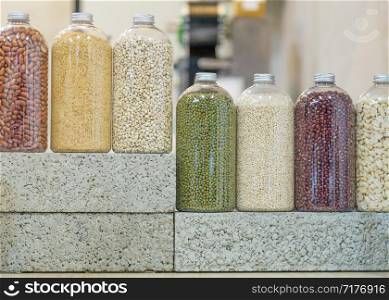 Bottles of seeds and legumes on bricks