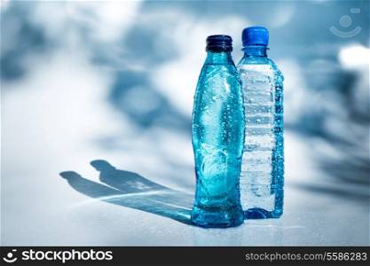 Bottles of water on blue background