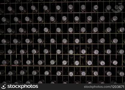 Bottles of wine in a metallic structure in a cellar or winery