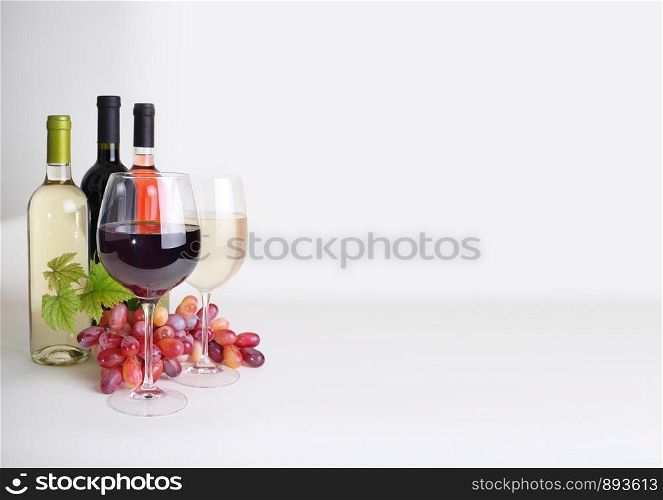 bottles of wine, wineglass and grapes