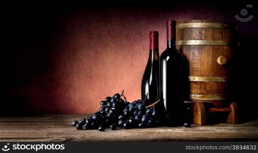 Bottles of wine with cask and grape