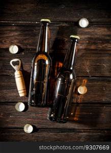 Bottles with beer and opener. On wooden background.. Bottles with beer and opener.