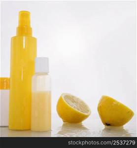 bottles with skincare products near lemon