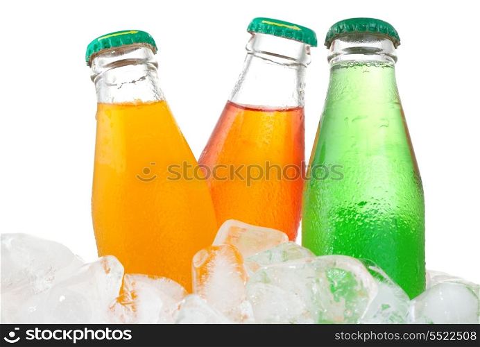 Bottles with soda in ice on white background