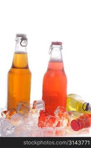 Bottles with tasty drink in ice