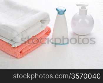 bottles with two towels on white background