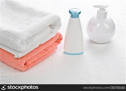 bottles with two towels on white background