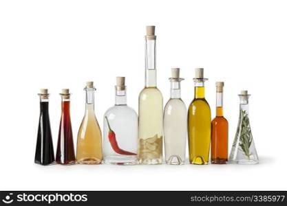 Bottles with various types of oil and vinegar on white background