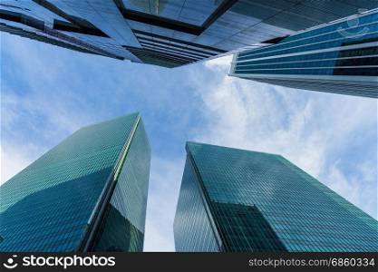 Bottom view of modern skyscrapers in business district against blue sky, Skyscraper Building Looking Up Blue Sky and Clouds