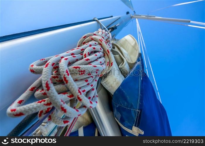Bottom view of the mast of a sailing yacht. A hank of rope and other rigging. Rope Hank Hangs on the Mast of a Sailing Yacht