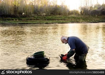 BOUCOIRAN, FRANCE - MARCH 16: Gold digger in France in the region of Cevennes and the department of Gard in the middle of the river called Le Gardon, march 16, 2014