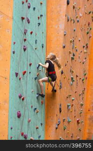 bouldering, little girl climbing up the wall