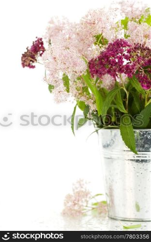 Bouqet of flowers in a pot over white