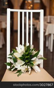 Bouquet from beige roses on a striped chair.. Bouquet on a chair 842.