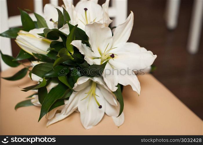 Bouquet from beige roses on a striped chair.. Bouquet on a chair 843.