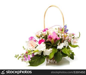 Bouquet from different pink seasonal flowers of september in basket isolated on white