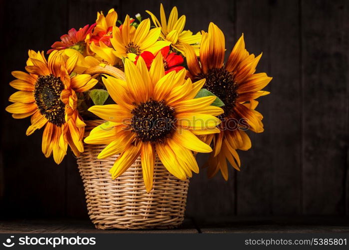 Bouquet from sunflowers in basket on the table