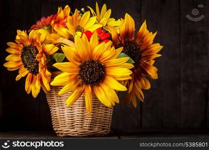 Bouquet from sunflowers in basket on the table