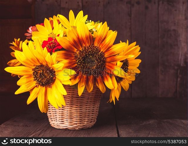Bouquet from sunflowers in basket on the table
