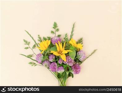 Bouquet from variety of wildflowers on a beige background.. Bouquet from variety of wildflowers on beige background.