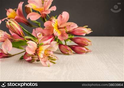 Bouquet of a beautiful alstroemeria flowers on wood. Lily flower. Chalkboard background