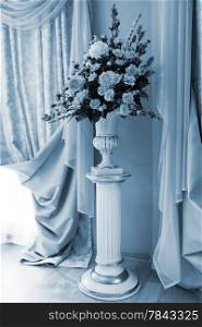bouquet of beautiful flowers in the vase near the window