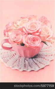 Bouquet of beautiful fresh pink roses in pink cup. Pink roses in pink pot