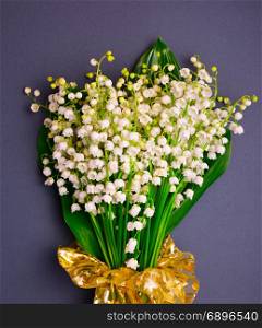bouquet of blossoming lilies of the valley on a black background