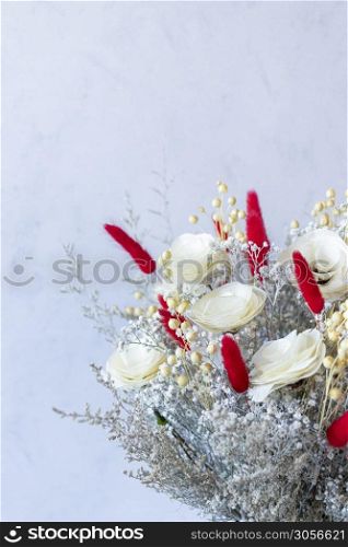 Bouquet of colorful dried flowers and white roses