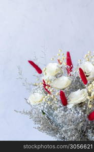 Bouquet of colorful dried flowers and white roses