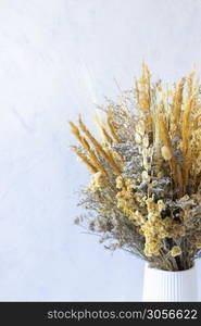 Bouquet of colorful dried flowers and yellow spikes