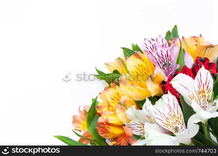 Bouquet of colorful flowers alstroemeria on white background. Flat lay. Horizontal. Mockup with copy space for greeting card, social media, flower delivery, Mother?s day, Women?s Day
