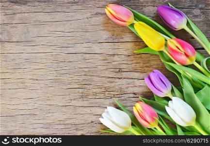 bouquet of colorful tulips on rustic wooden board, easter decoration