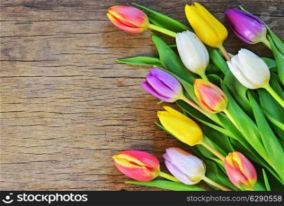 bouquet of colorful tulips on rustic wooden board, easter decoration&#xA;