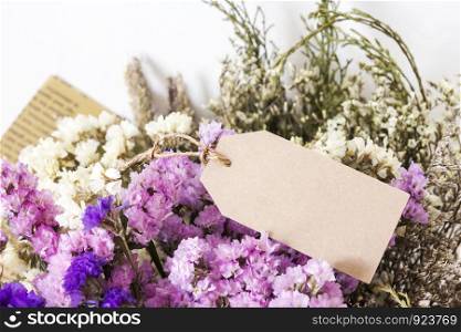 Bouquet of dried flowers with blank paper tag