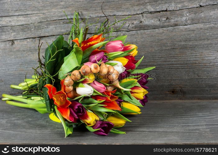 bouquet of fresh colorful spring tulip flowers over rustic wooden background