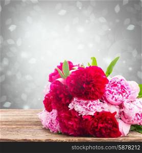 bouquet of fresh pink and red peonies on wooden table . pink and red peonies