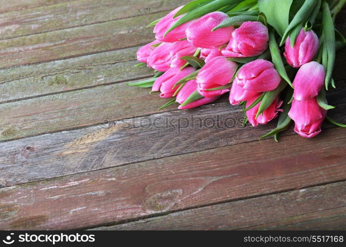 bouquet of fresh pink tulips on wooden background