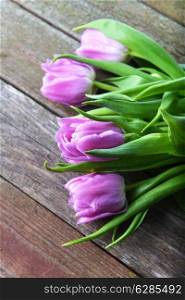 bouquet of fresh pink tulips on wooden background