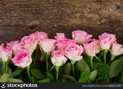 bouquet of fresh roses. bouquet of pink fresh roses on wooden background