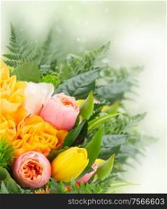 bouquet of fresh spring rose and tulip flowers on green bokeh background. bouquet of fresh spring flowers